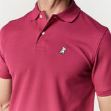 Close-up of the chest area, highlighting the embroidered logo on the burgundy polo shirt.