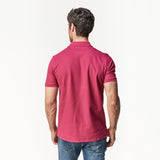 Rear view of the man wearing the burgundy polo shirt, displaying the back fit and style.