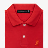 Close-up of the collar and chest area of the red polo shirt, showing the button placket and gold embroidered logo.