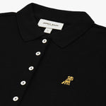 Close-up of the chest, highlighting the collar and gold logo detail on the polo shirt.