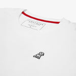 A white T-shirt laid flat, showing the small logo on the front and black text on the back.