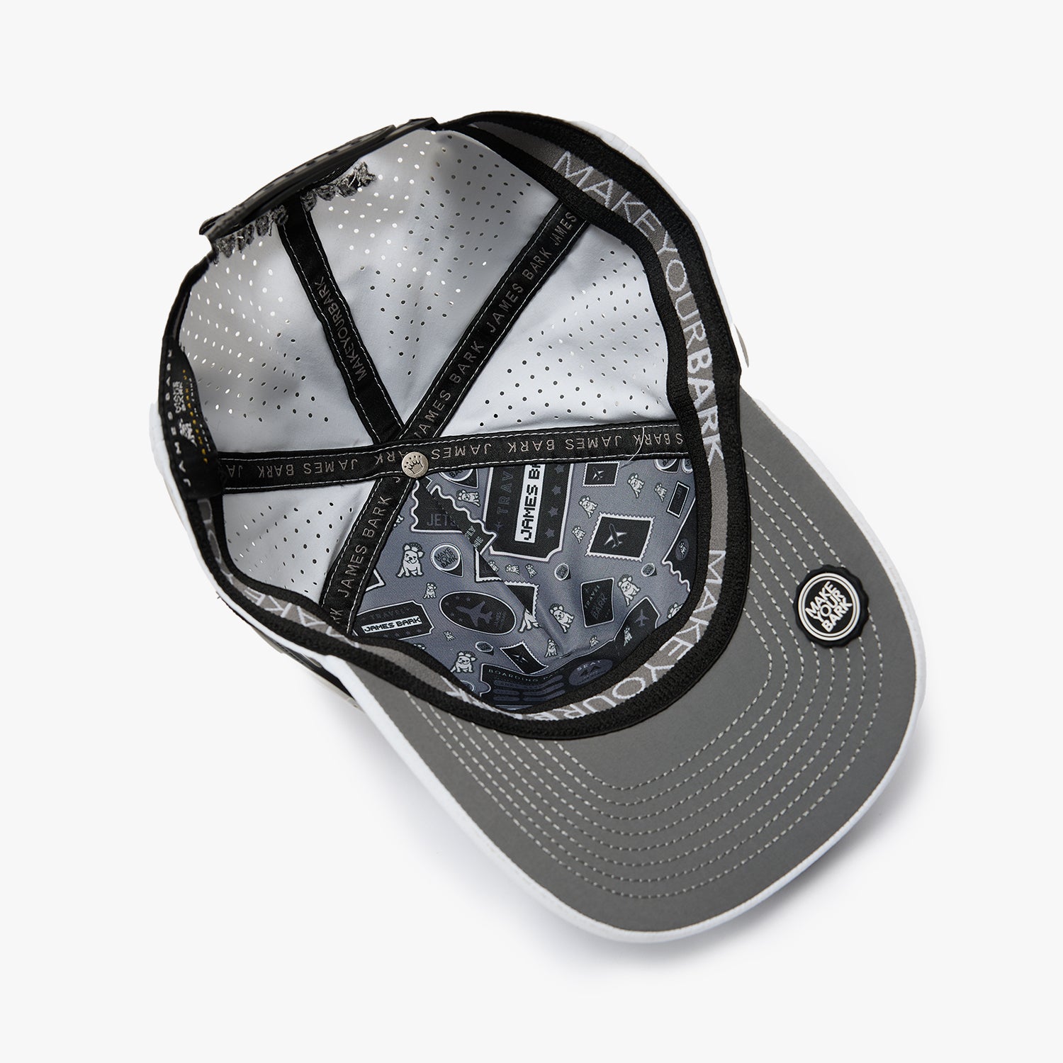 An overhead view of a gray snapback cap with a black brim, black mesh back panels, and a black adjustable strap. 