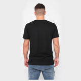 A rear view of a man wearing the black T-shirt and jeans.