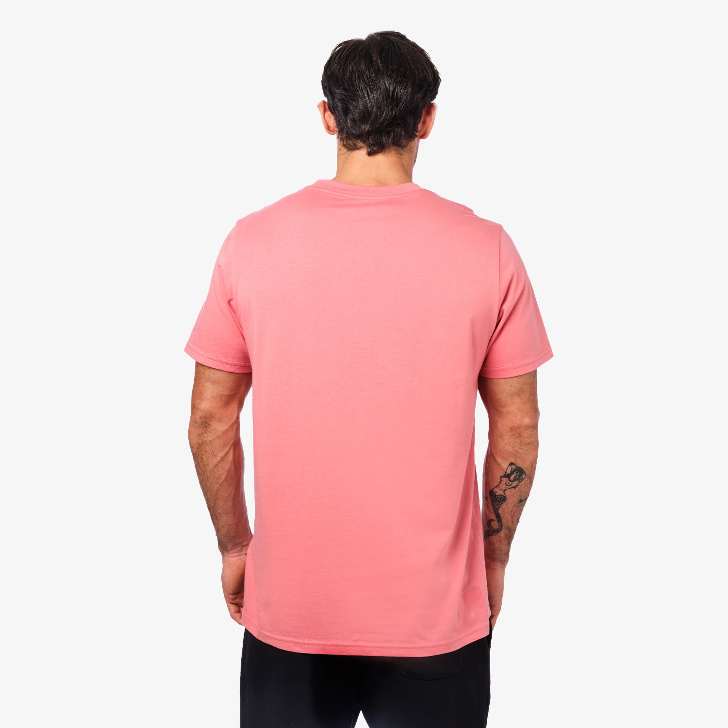 Back view of a man wearing the pink t-shirt: The man is standing with his back to the camera, showing the simple back design of the t-shirt.