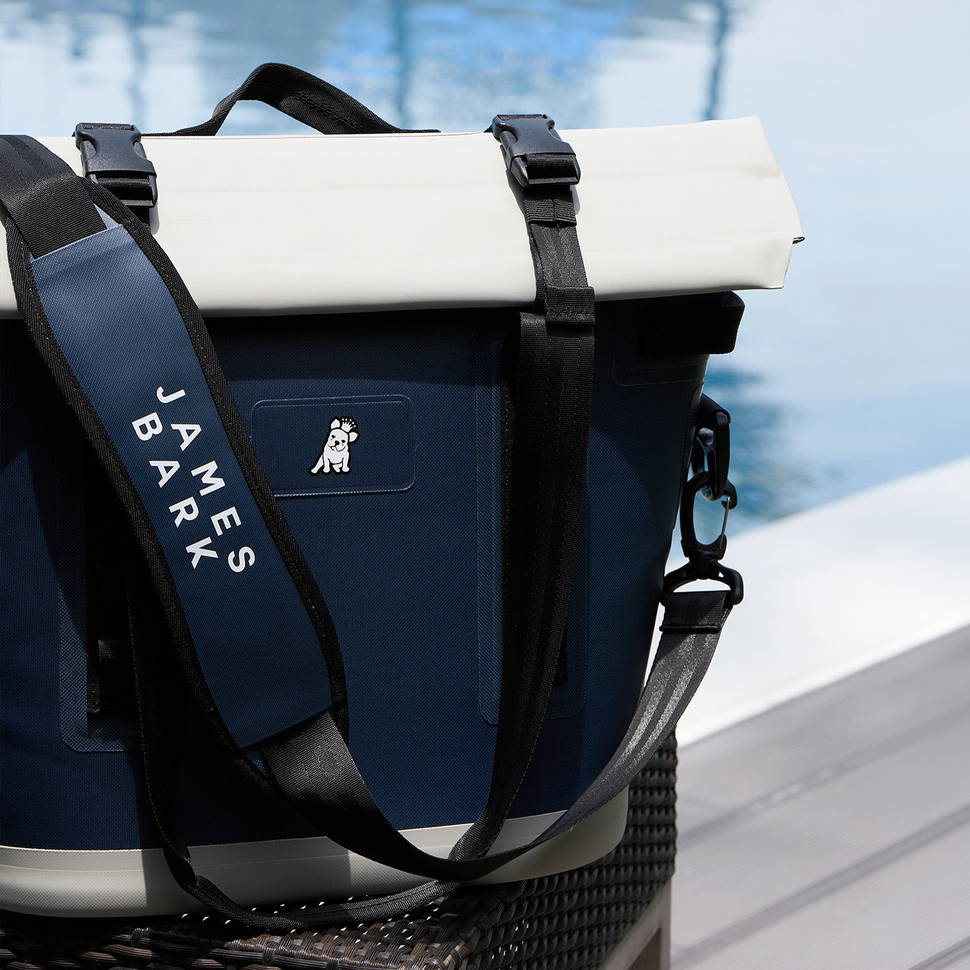 Blue cooler bag with white top and black strap featuring 'James Bark' branding.