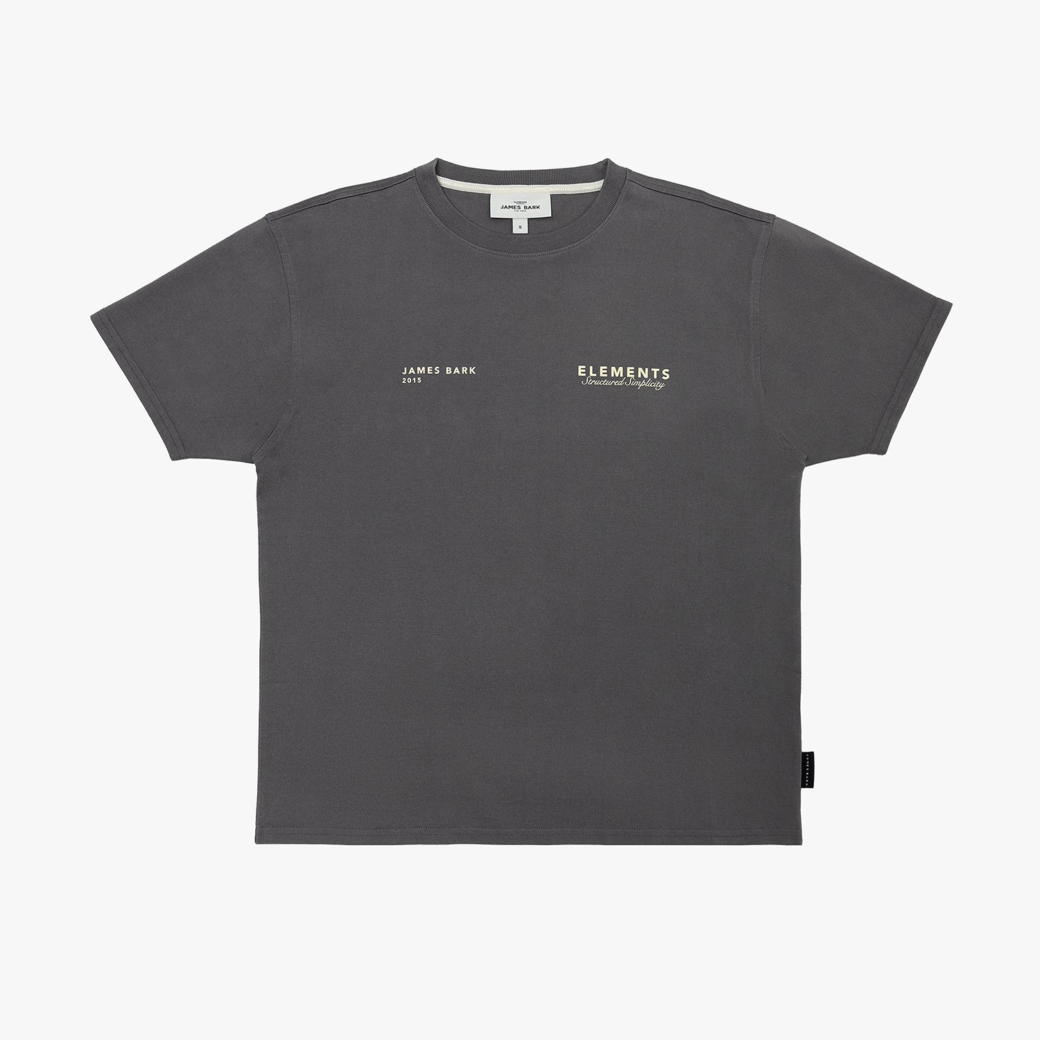 A dark gray T-shirt by James Bark Elements, featuring small white text logos on the left chest, displayed flat