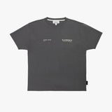 A dark gray T-shirt by James Bark Elements, featuring small white text logos on the left chest, displayed flat