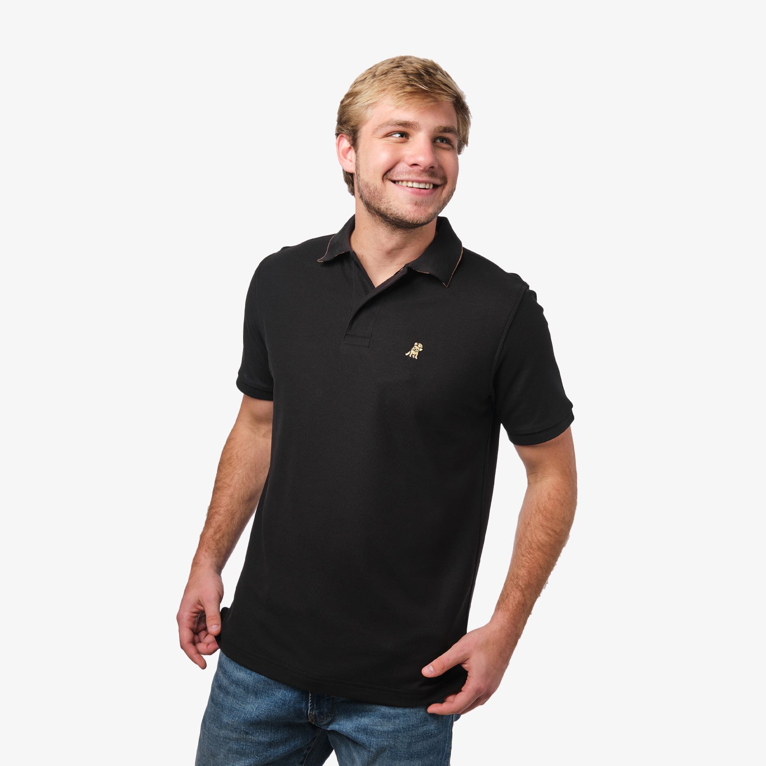 Full-body view of a man wearing the black polo shirt and jeans: The man is standing with a relaxed posture, one hand in his pocket, displaying the fit of the polo shirt.