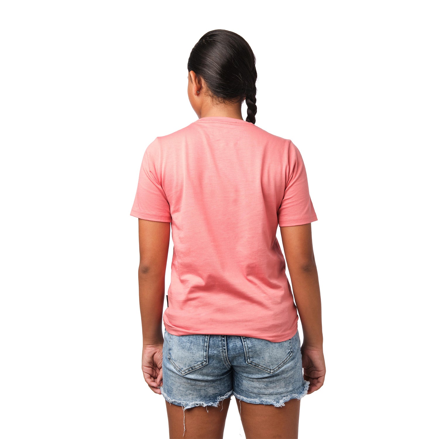 Rear view of a girl wearing the pink t-shirt, standing with her hands behind her back.