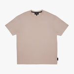 A light beige crewneck t-shirt with a subtle tonal logo on the chest, displayed flat