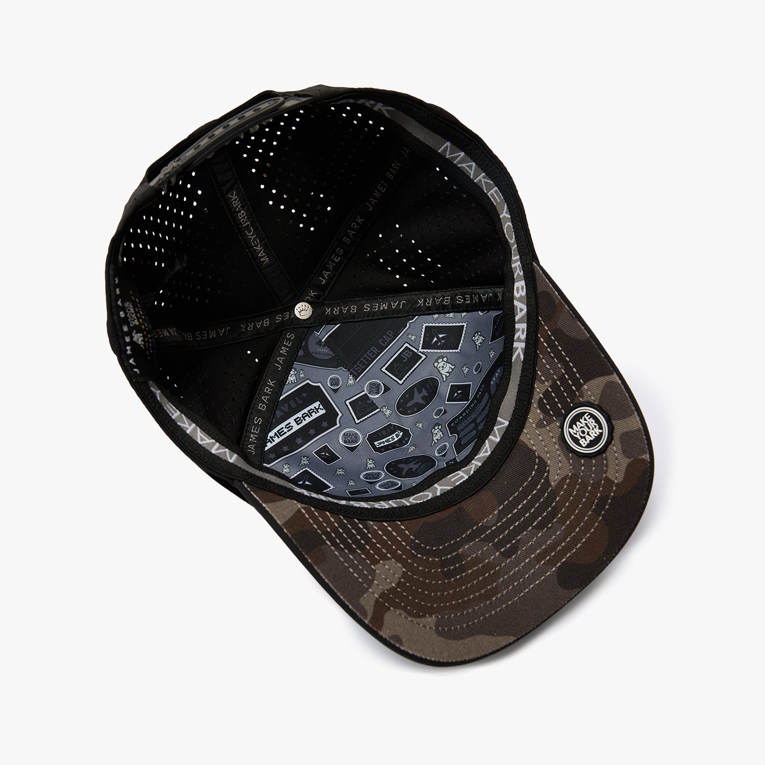 A black and brown camouflage baseball cap shown from an overhead angle, featuring a black mesh back, a patterned visor, and a circular patch on the side.
