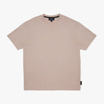 A light beige crewneck t-shirt with a subtle tonal logo on the chest, displayed flat