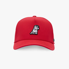 A red baseball cap featuring a small embroidered cartoon dog patch on the front, set against a clean white background.