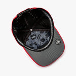 An overhead view of a structured baseball cap with a red and gray color-blocked design.