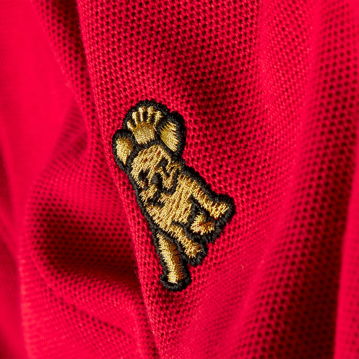Embroidered patch on a red fabric background