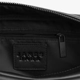 A close-up of the interior of the bag, showing the "James Bark" branded tag stitched inside, with details of the zippered inner compartment for additional organization.