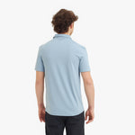 Person wearing a light blue polo shirt on a white background