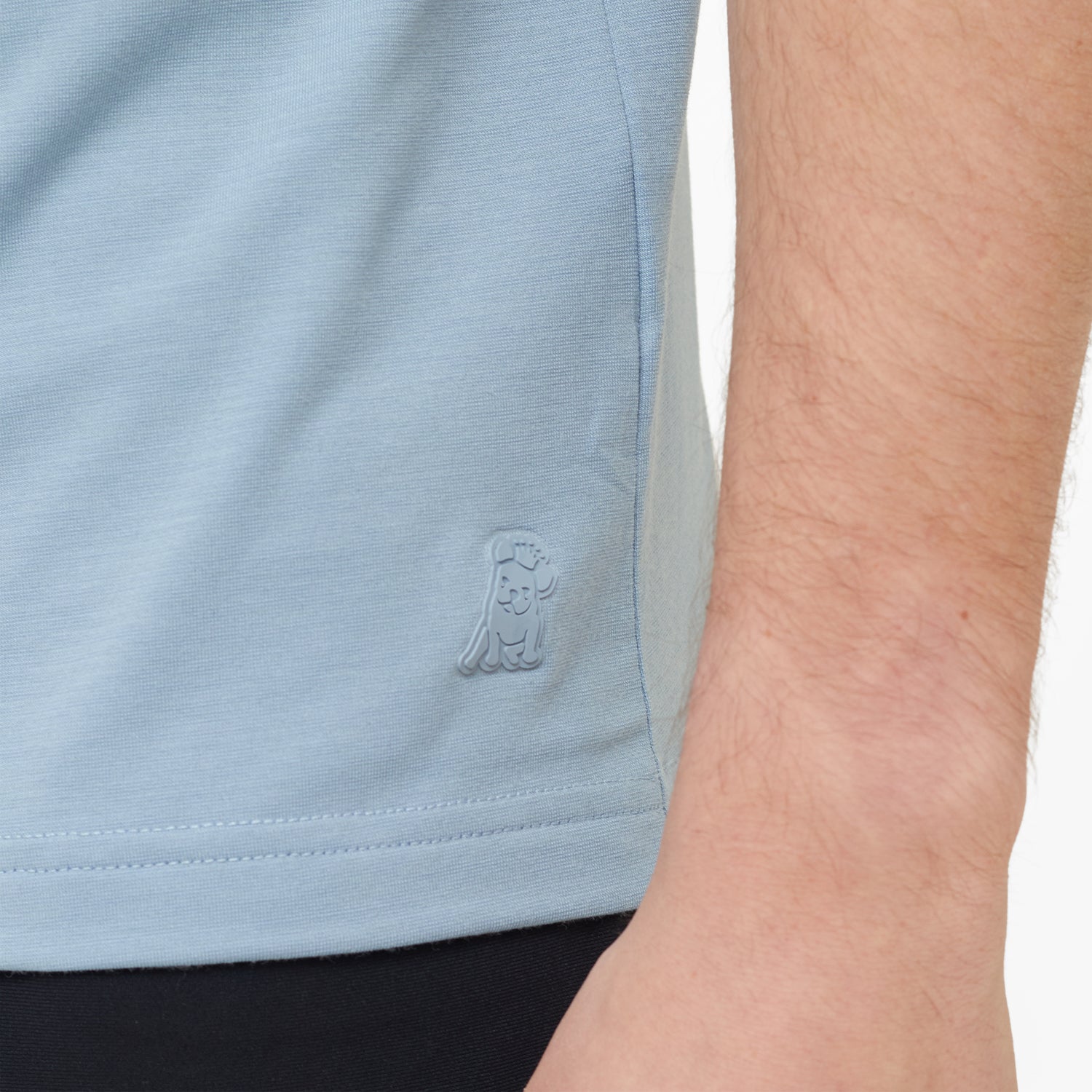 Light blue sleeveless shirt with a brand logo on a person wearing it.
