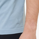 Light blue sleeveless shirt with a brand logo on a person wearing it.