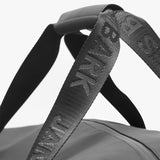  A close-up of the bag’s handles, displaying the "James Bark" branding embossed on the straps.