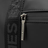 A close-up of the bag’s reinforced handle attachment, secured with metal buttons for durability.