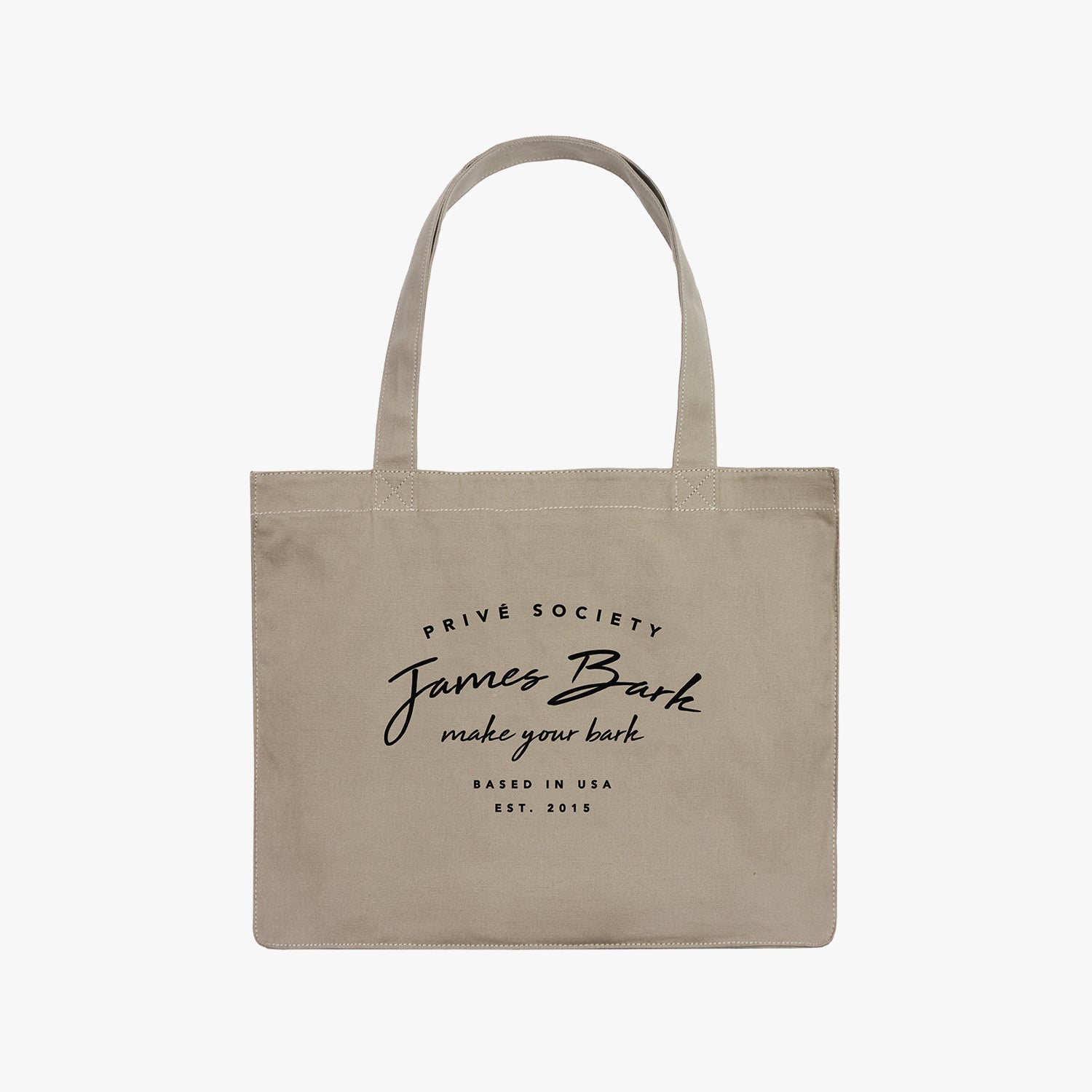 A beige canvas tote bag with black printed text that reads "PRIVE SOCIETY James Bark makes your look PARIS TO NYC EST. 2015." The bag has two sturdy handles and a minimalist design