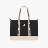 Black tote bag with beige accents and 'James Bark' branding on a white background