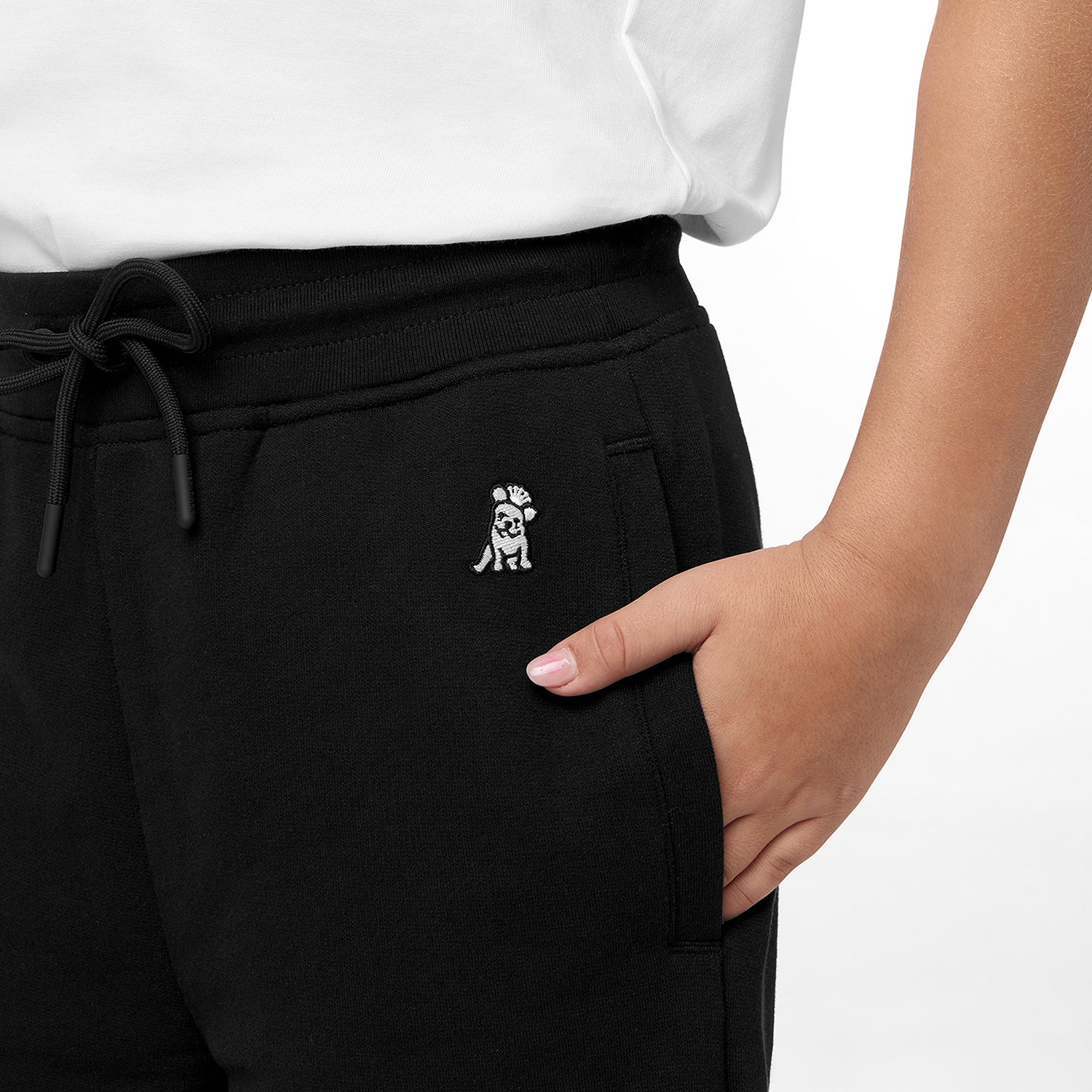 Close-up view of the jogger pants' pocket area showing an embroidered logo