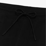 Close-up of the drawstring waistband on the black shorts, emphasizing the adjustable fit and fabric texture