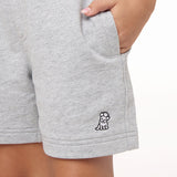 Close-up of the gray shorts pocket with the embroidered dog logo, highlighting the texture and details.