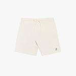 Flat-lay front view of cream-colored shorts featuring a minimalist design with a drawstring waistband and a small embroidered logo.