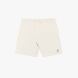 Flat-lay front view of cream-colored shorts featuring a minimalist design with a drawstring waistband and a small embroidered logo.