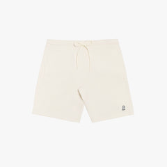 Flat-lay front view of cream-colored shorts featuring a minimalist design with a drawstring waistband and a small embroidered logo.