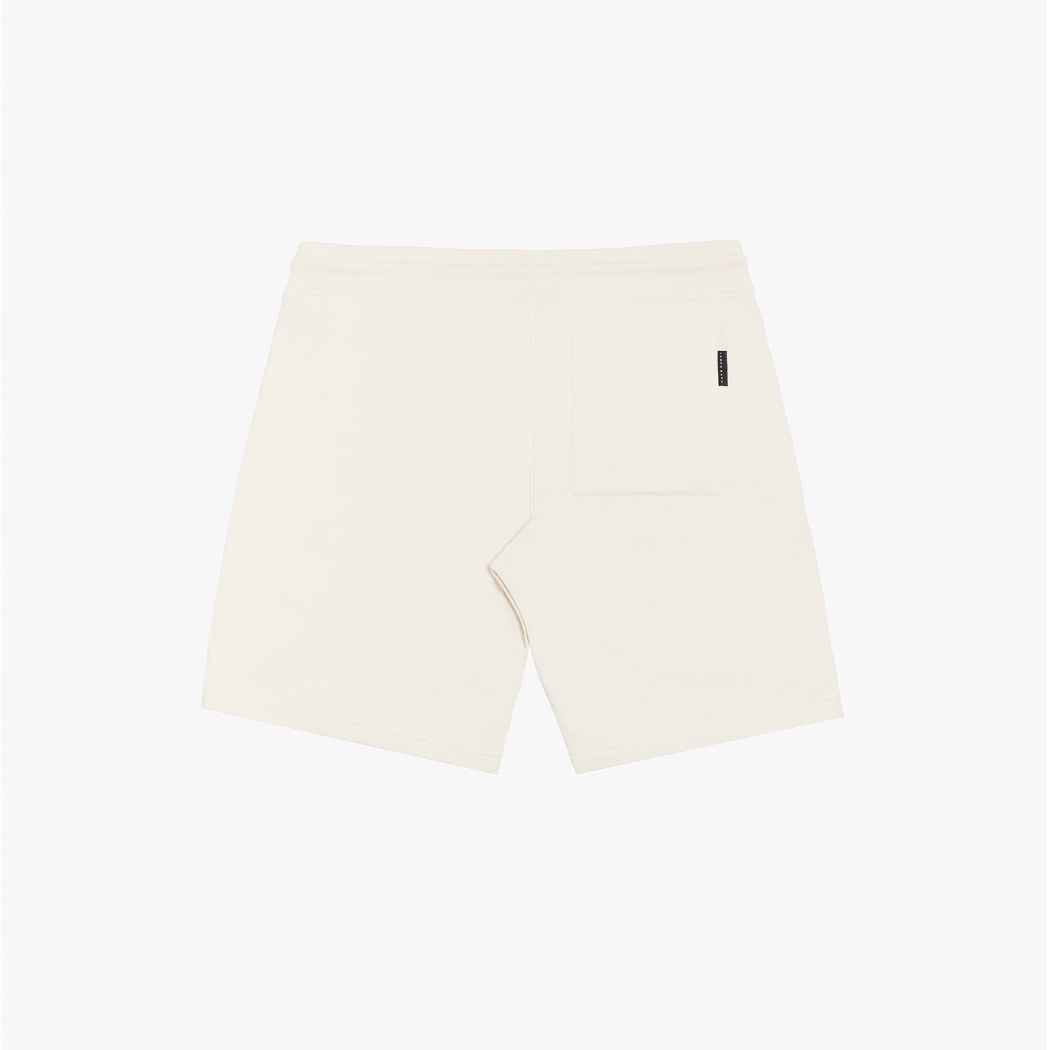 Flat-lay back view of cream-colored shorts, showcasing the clean design and subtle back pocket detail