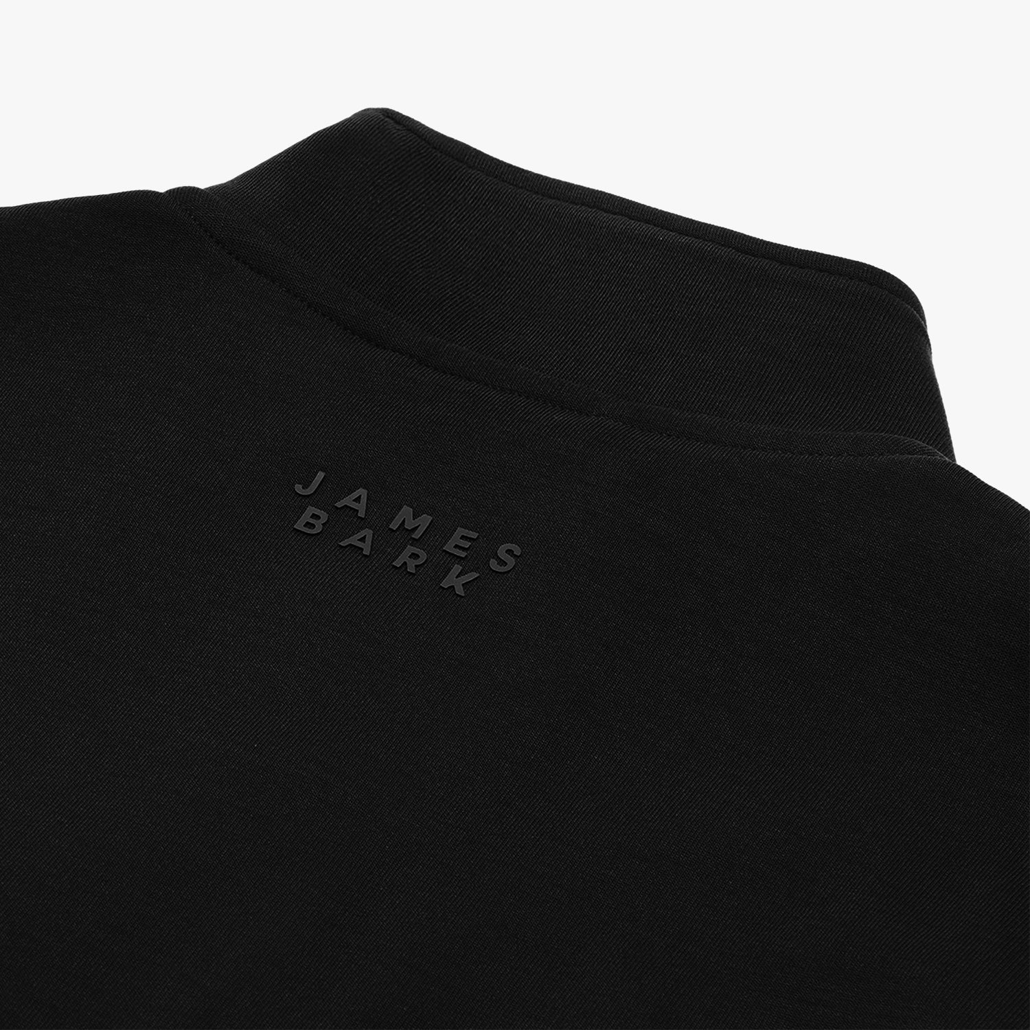 A close-up of the "James Bark" branding embroidered on the jacket’s back.