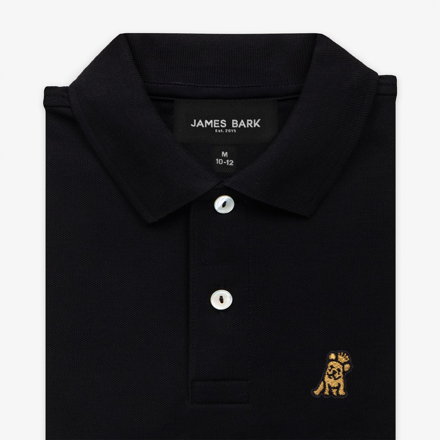 Close-up of the collar and chest area of the black polo shirt, showing the button placket and the gold embroidered logo.