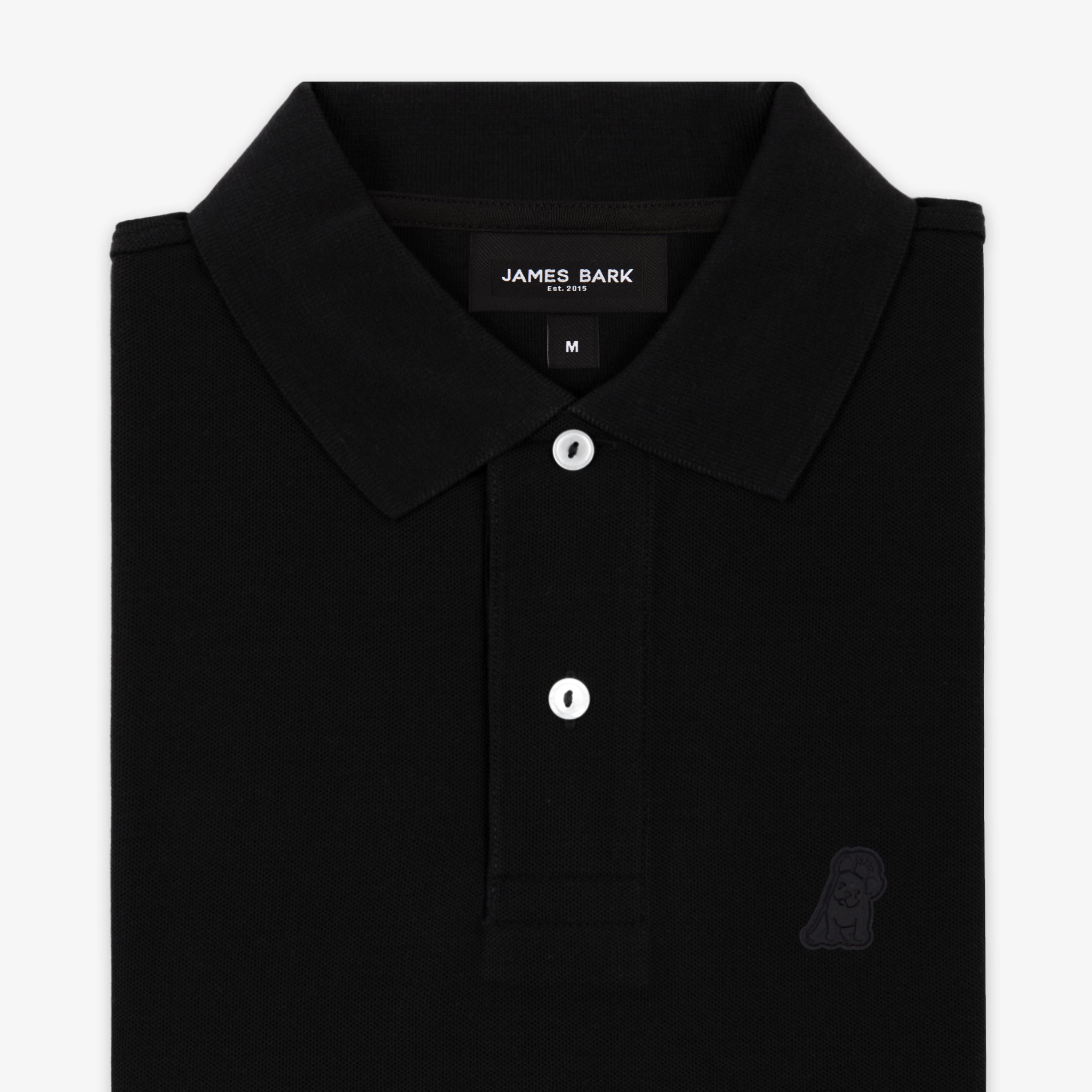 Close-up of the collar and buttons of the black polo shirt with a subtle black embroidered logo.
