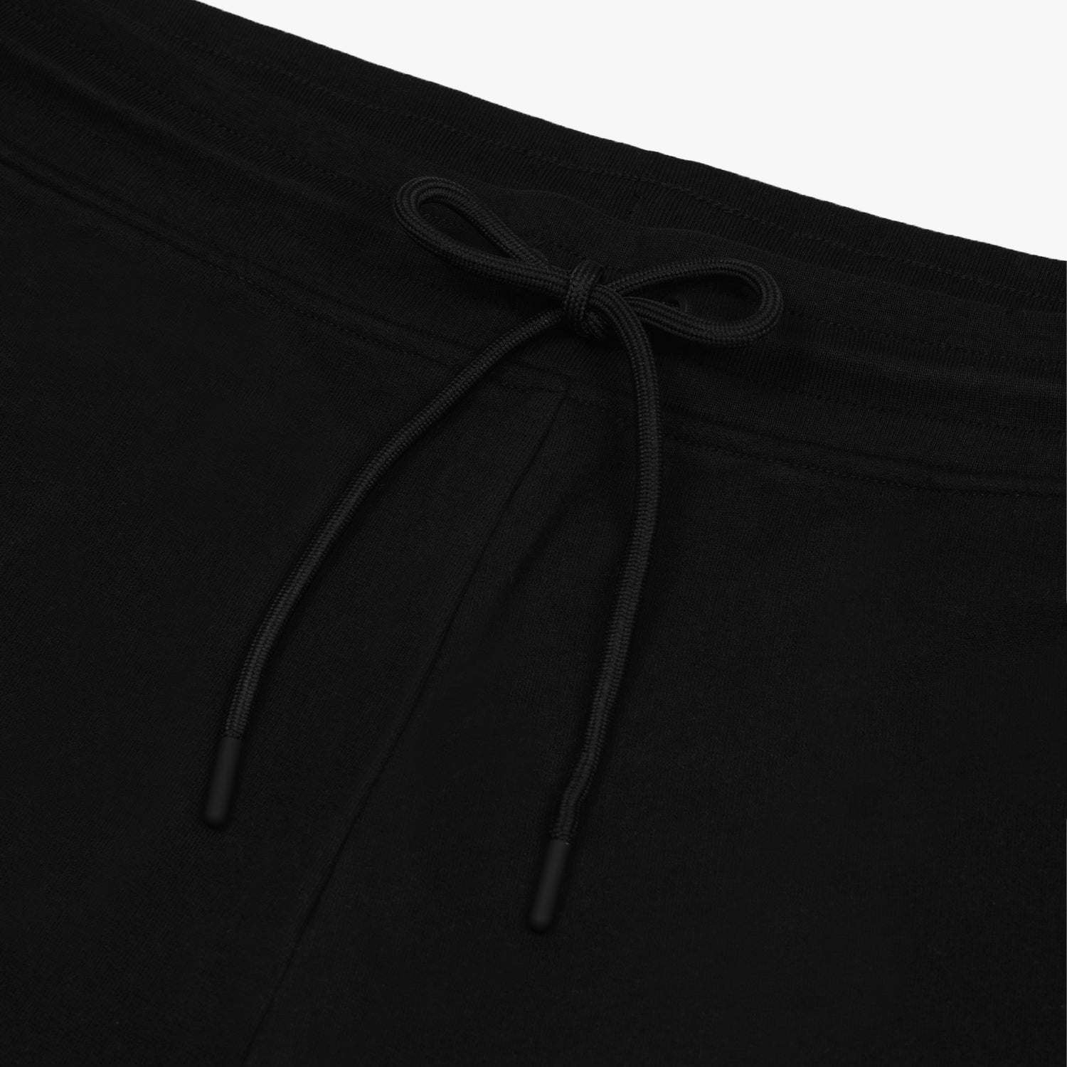 Close-up of the drawstring waistband on the black jogger pants, emphasizing the adjustable fit and clean design