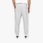 Back view of a person wearing light gray jogger-style sweatpants with a single back pocket, paired with white sneakers featuring black accents. The person is also wearing a white T-shirt, and the background is plain white." Let me know if any edits are needed