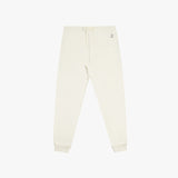 Flat-lay front view of cream-colored jogger pants with cuffed ankles and a drawstring waistband