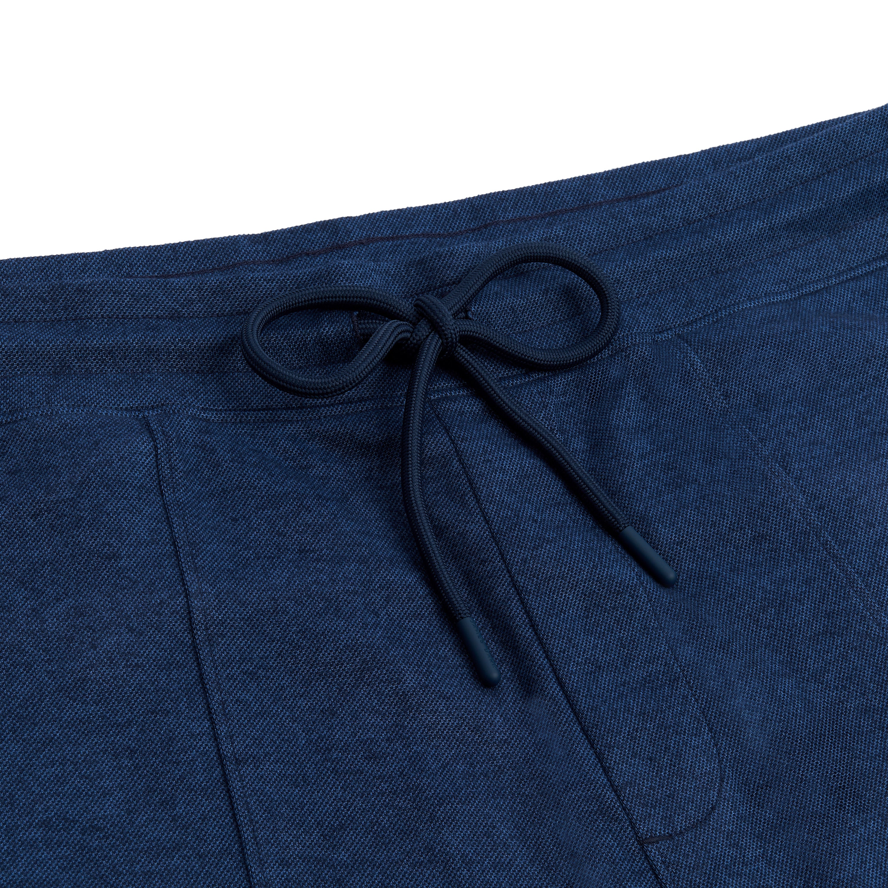 A close-up of the drawstring at the waistband, indicating an adjustable waist.