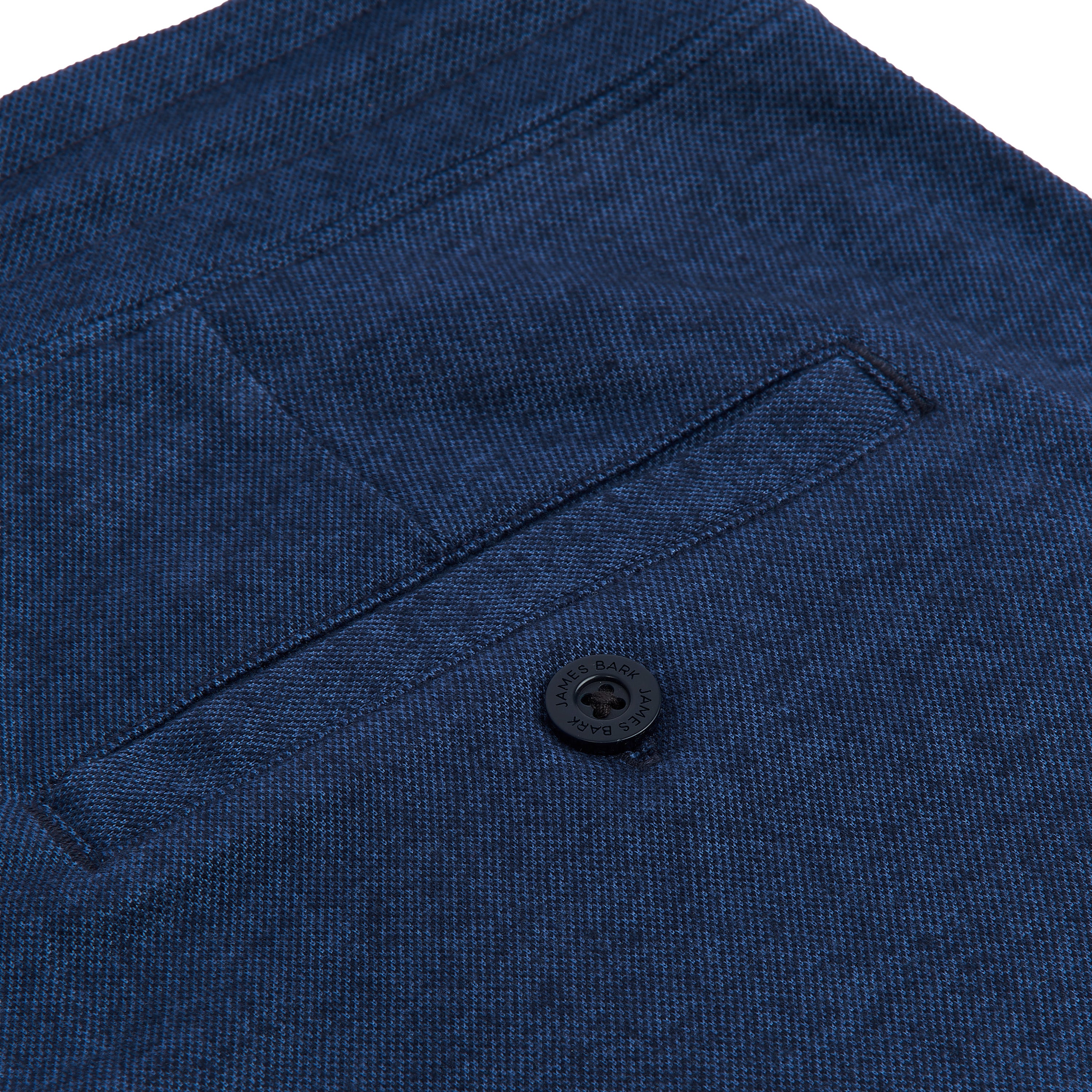 A close-up of the back pocket with a button, highlighting the detailing and style.