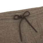 Close-up of the pants' elastic waistband with a tied brown drawstring for adjustment