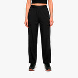 Person wearing black high-waisted pants on a white background