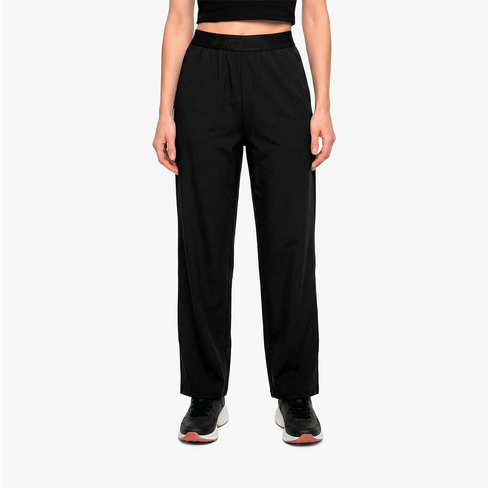 Person wearing black high-waisted pants on a white background