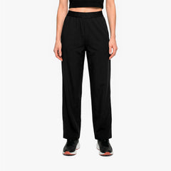 Person wearing black high-waisted pants on a white background