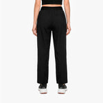 Person wearing black high-waisted pants on a white background
