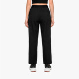 Person wearing black high-waisted pants on a white background