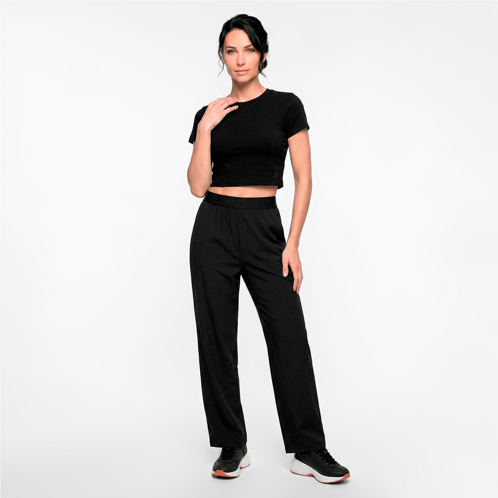 Woman wearing a black outfit on a white background
