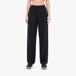 Person wearing black wide-leg pants on a white background